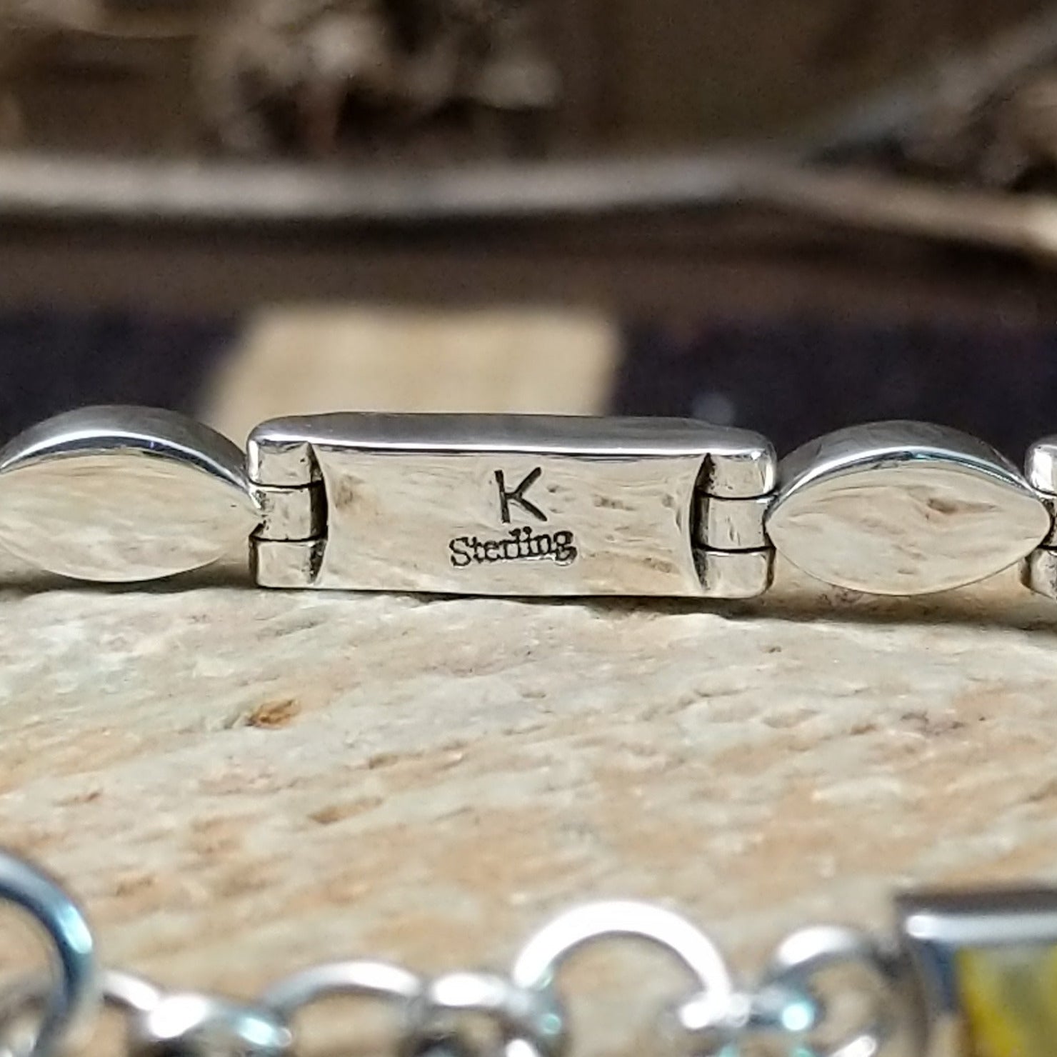 Close-up of the artisan's stamped initial.