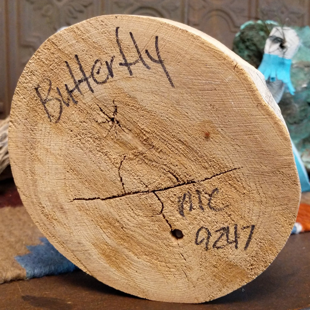 The base showcases the title of the piece and artisan's initials.