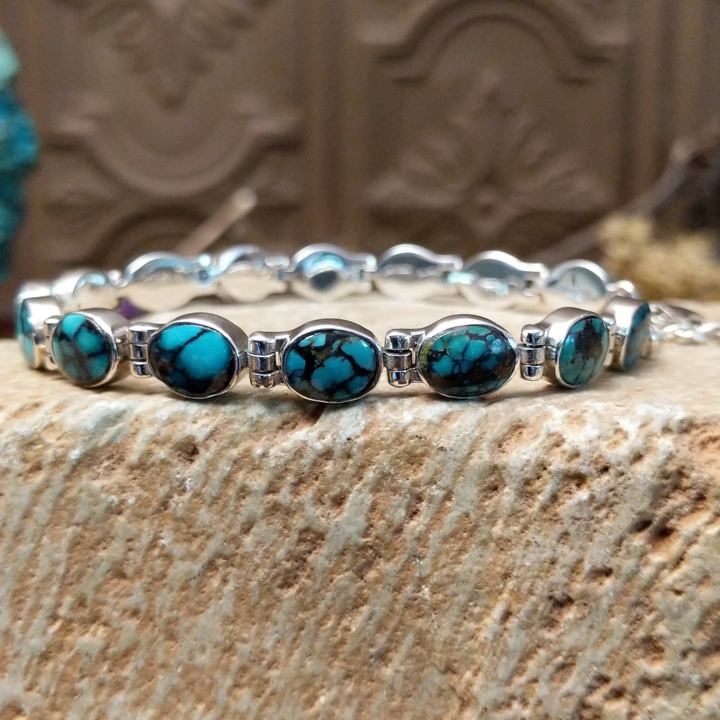 Sterling silver link bracelet with Chinese turquoise set in oval bezels.