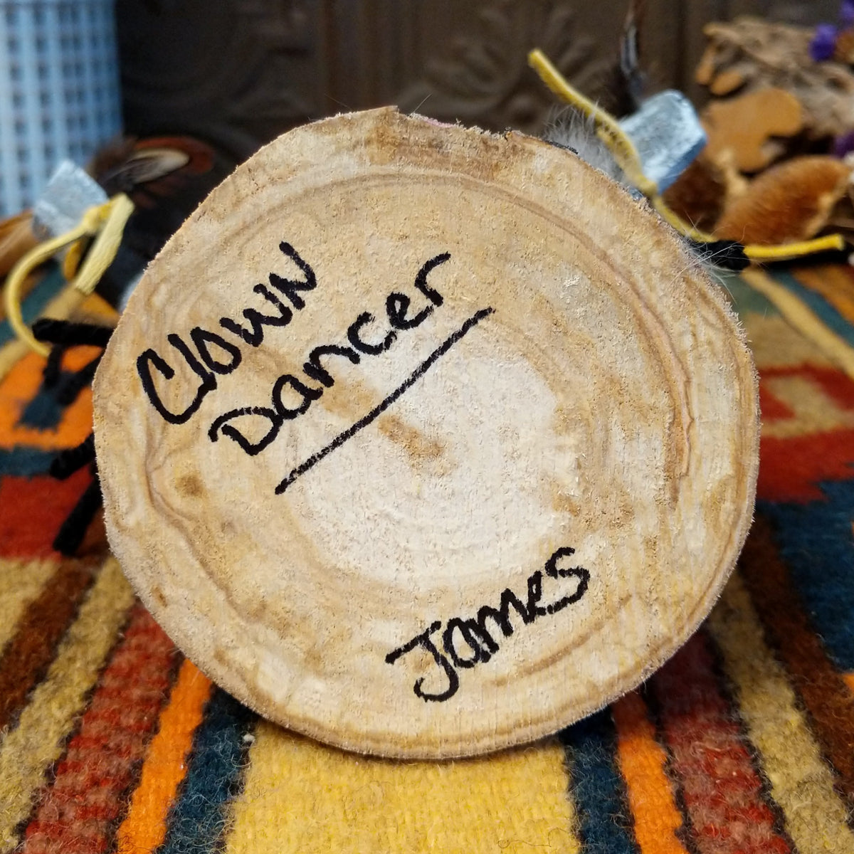 Underside of Navajo Clown Dancer Kachina doll base with handwritten figure name and artist surname.