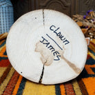 Underside of Navajo Ogre Kachina doll base with handwritten figure name and artist surname.