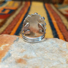Rear view of the underside of a coral cluster ring showing the polished split-shank construction and stamped STERLING hallmark on the back of the setting.