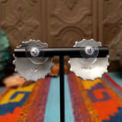 Navajo sterling silver matching earrings by B.Y., featuring numerous red-orange coral stones arranged in floral clusters; back side of earrings.