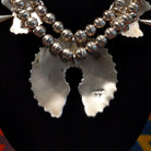 Artisan and Sterling Silver stamp on back of necklace.