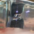 Close-up of the artisan's stamped signature.