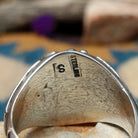 Handcrafted Navajo sterling silver ring featuring two natural red coral cabochons and one blue turquoise cabochon with traditional sawtooth bezels, silver raindrop accents, and a split-shank band; artisan and Sterling Silver stamp.