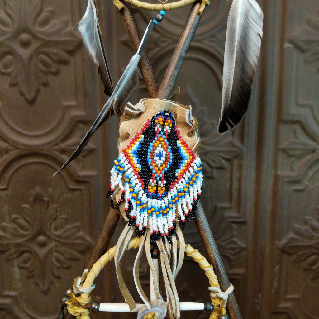 Close-up of the medicinal pouch with decorative, vibrant beads and fringe.