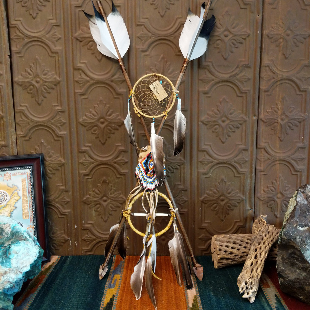 Cross arrow Mandela with feathers, arrows, beading, and other various materials.