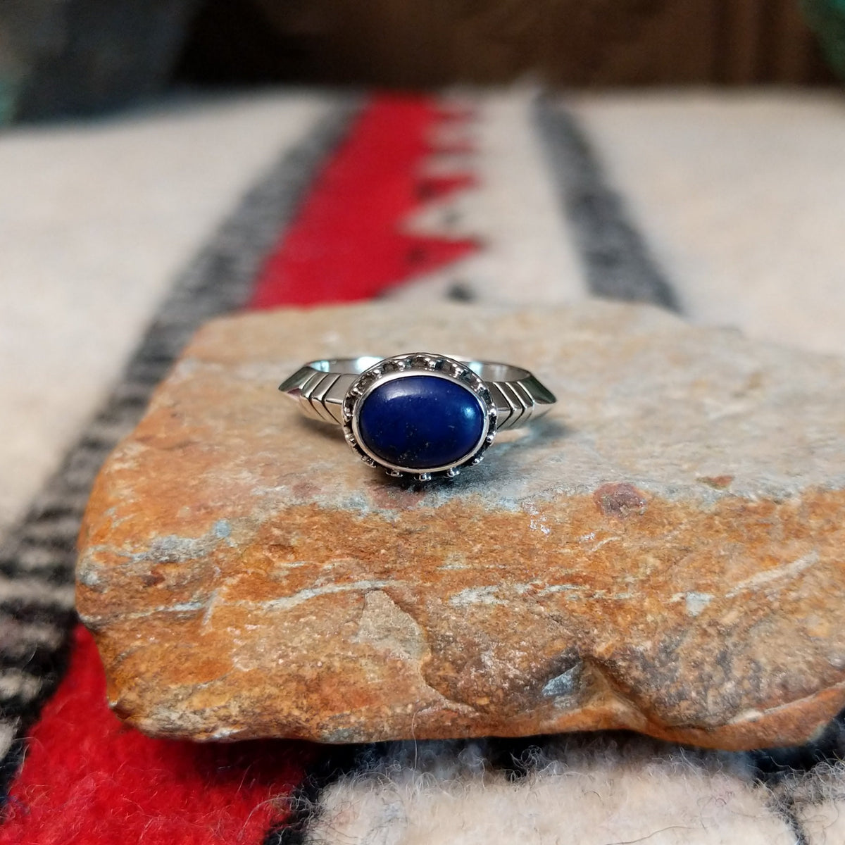 Navajo silver ring with lapis stone and ornate crown-style setting.
