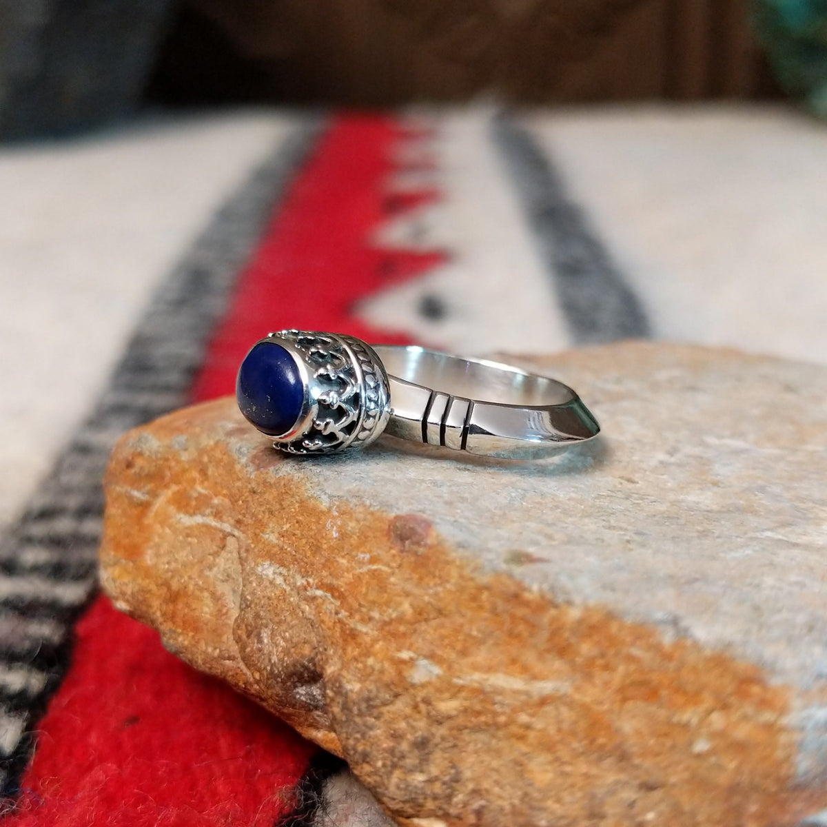 Navajo silver ring with lapis stone and ornate crown-style setting.