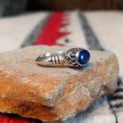 Navajo silver ring with lapis stone and ornate crown-style setting.