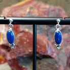 Sterling silver post earrings with lapis set in the bezels, framed by dotted accents.
