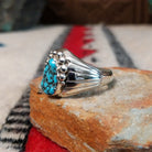 Navajo turquoise ring by S. with graduated silver drop accents.