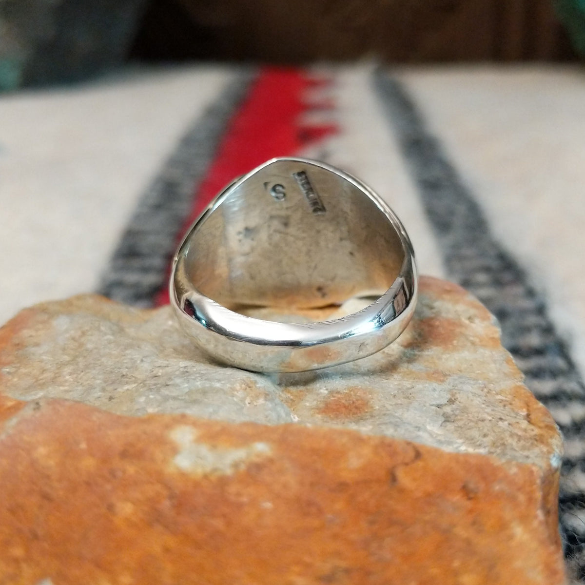 Navajo turquoise ring by S. with graduated silver drop accents.