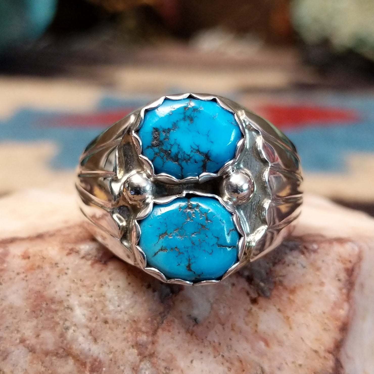 Sterling silver ring with dual turquoise set in scalloped bezels.