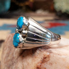 Sterling silver ring with dual turquoise set in scalloped bezels.