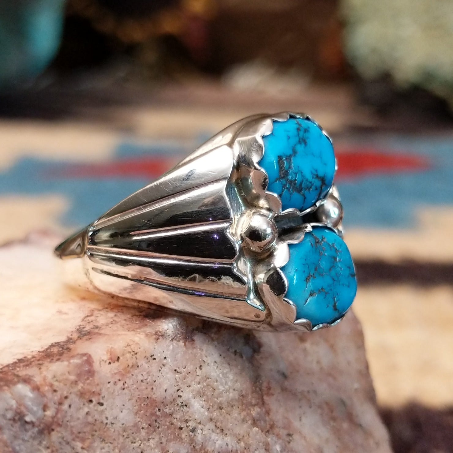 Sterling silver ring with dual turquoise set in scalloped bezels.