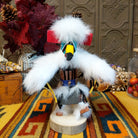 This striking Navajo Eagle Dancer Kachina by Debbie James features a colorful hand-painted eagle mask, white feather wings, fluffy headdress, leather ties, decorative clothing, and a wooden display base.