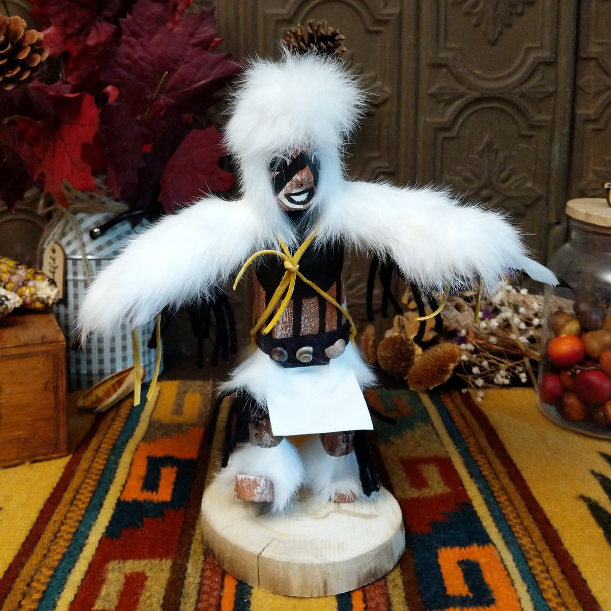 Navajo Eagle Kachina doll with wide outstretched white feather wings, white fur headdress, black painted facial markings, and white fabric apron.