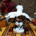 Back view of the Navajo Eagle Kachina doll with wide outstretched white feather wings, white fur headdress, black painted facial markings, and white fabric apron.