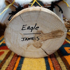 Underside of Navajo Eagle Kachina doll base with handwritten figure name and artist surname.