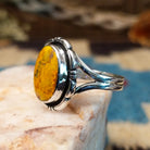 Sterling silver ring with bumblebee jasper set in the oval bezel, framed by the etched setting.
