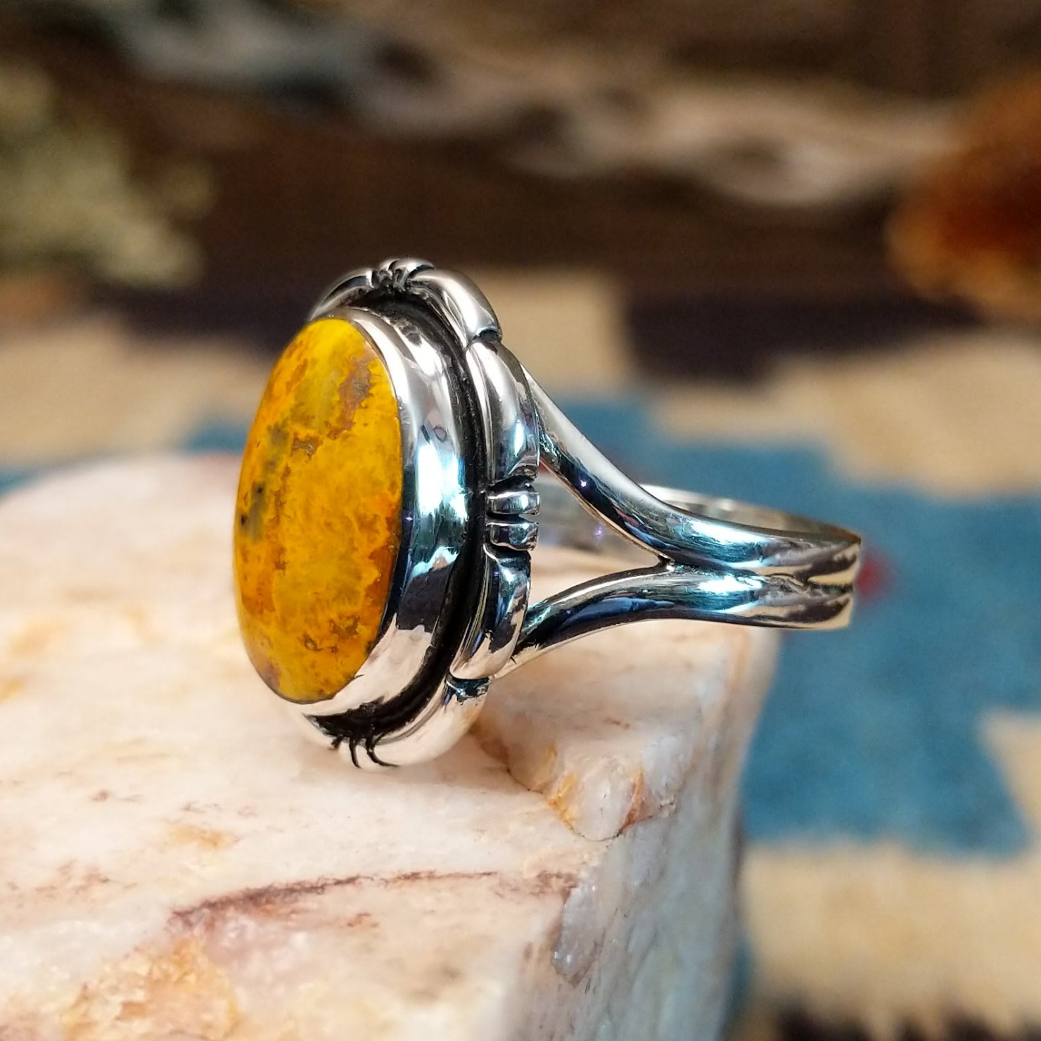 Sterling silver ring with bumblebee jasper set in the oval bezel, framed by the etched setting.