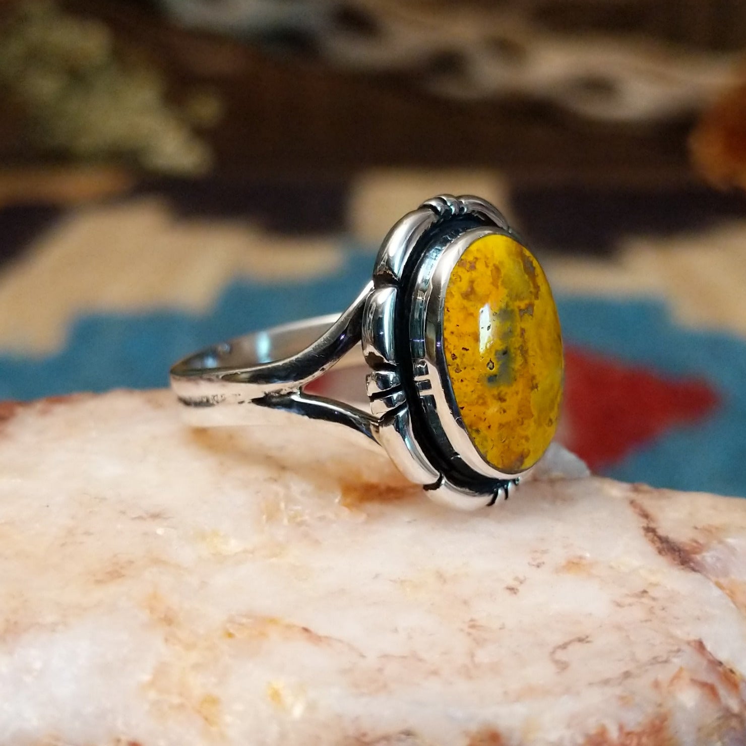 Sterling silver ring with bumblebee jasper set in the oval bezel, framed by the etched setting.