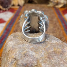 Sterling silver ring with coral set in the bezels creating a floral like motif and twisted rope accents around the center bezel.