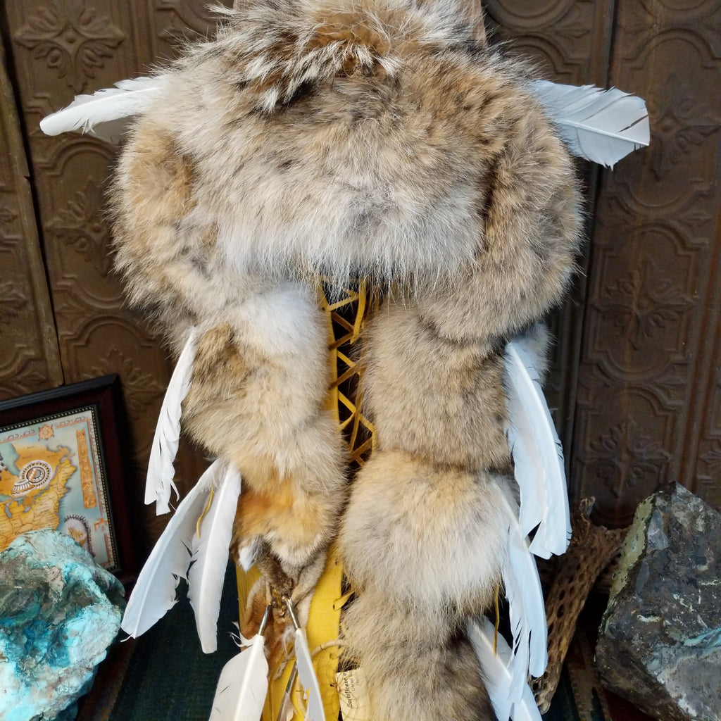Fox fur, wood, and leather crafted into a cradlebaord with feathers and decorative beading.