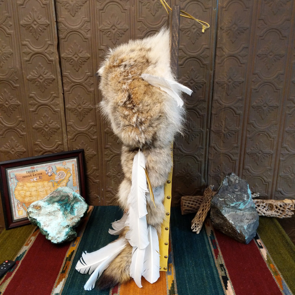 The side of the piece showcases its' slim form with decorative feathers.