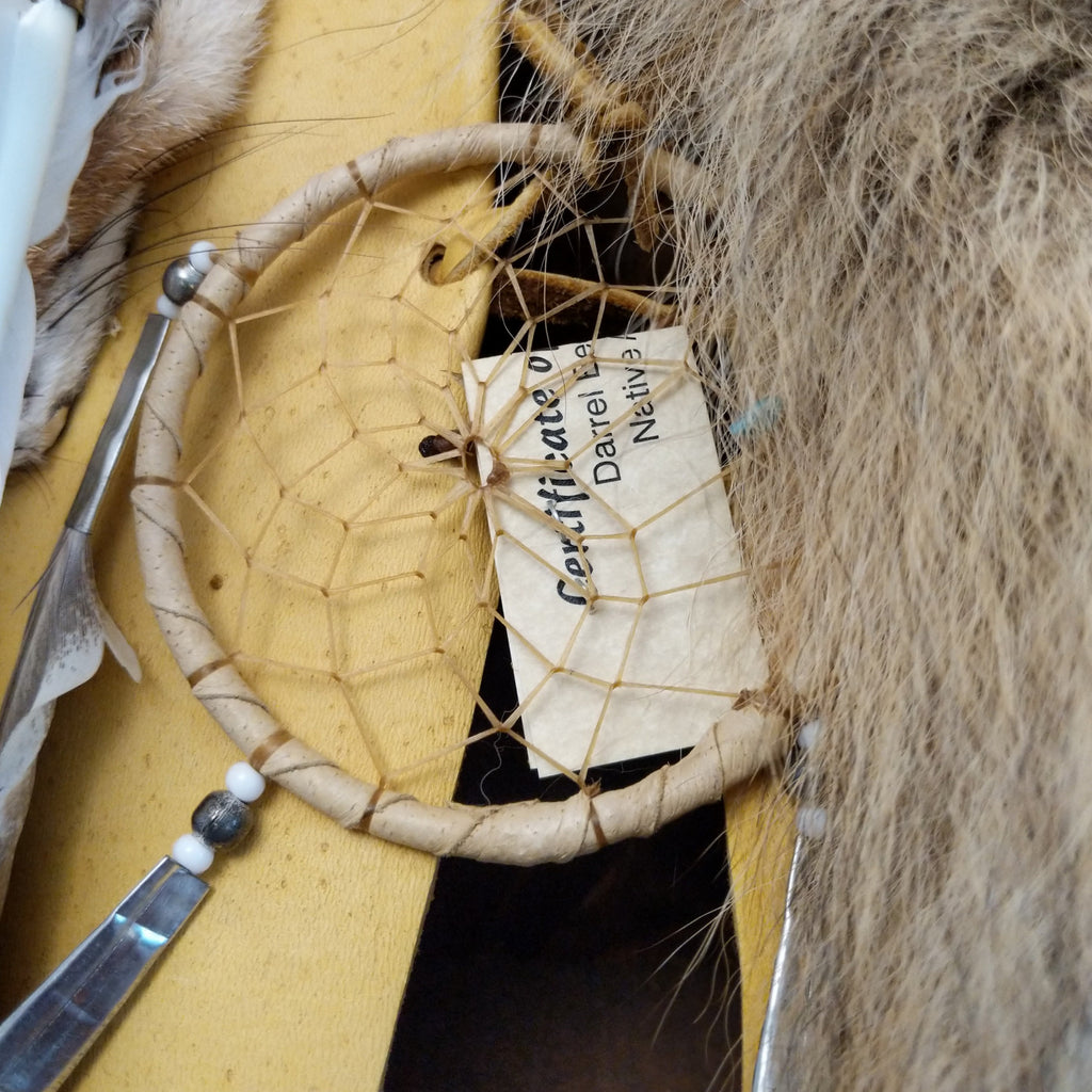 A close-up of the dream catcher and authentication tag found on the cradleboard.