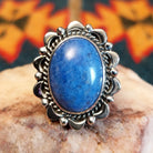 Sterling silver ring with denim lapis set in the bezel, framed by ornate and frilled silverwork.