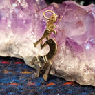 Navajo gold Kokopelli pendant with flute-playing figure.