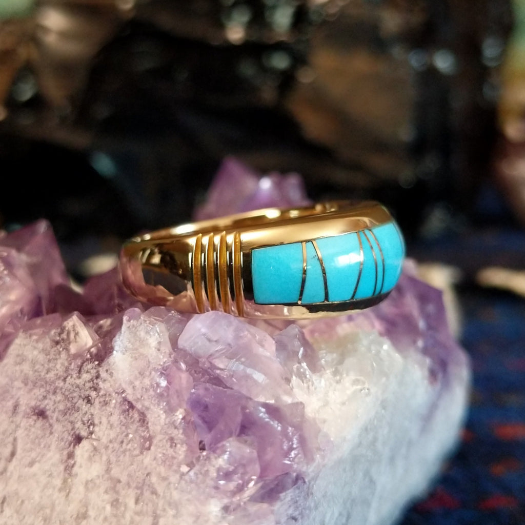 Gold band ring featuring a smooth turquoise inlay set in 14k gold.