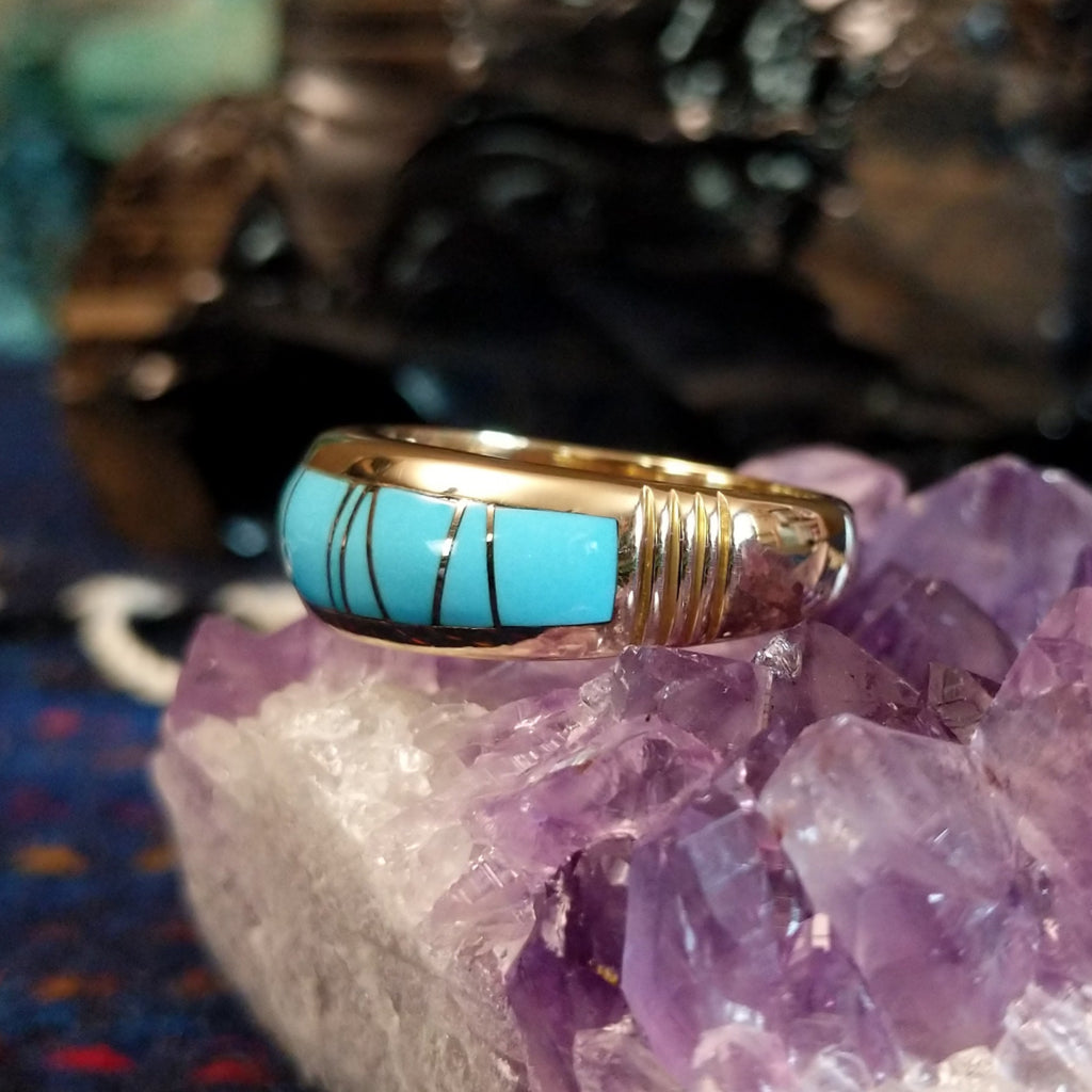 Gold band ring featuring a smooth turquoise inlay set in 14k gold.
