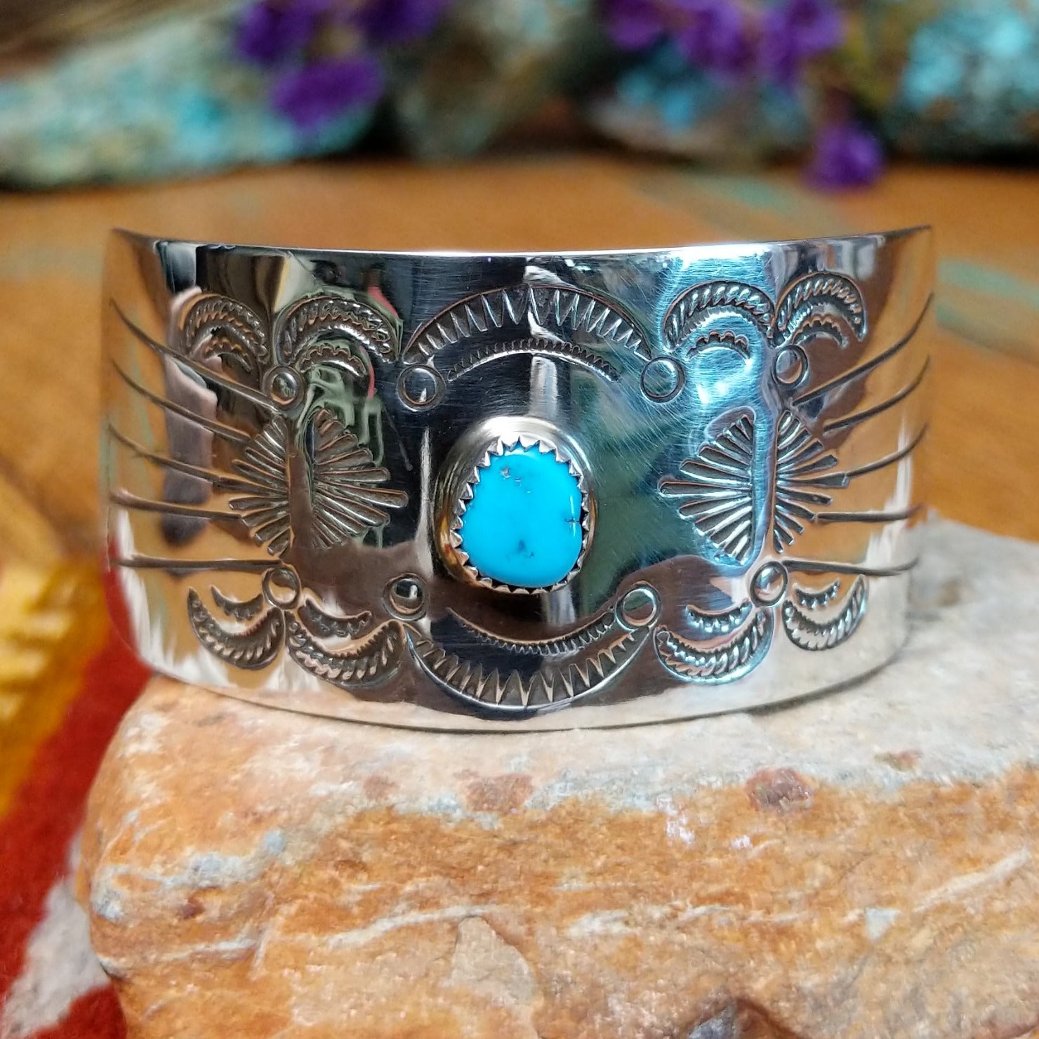 Sterling silver Navajo barrette with hand-stamped design and centered turquoise stone.