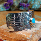 Sterling silver Navajo barrette with hand-stamped design and centered turquoise stone.