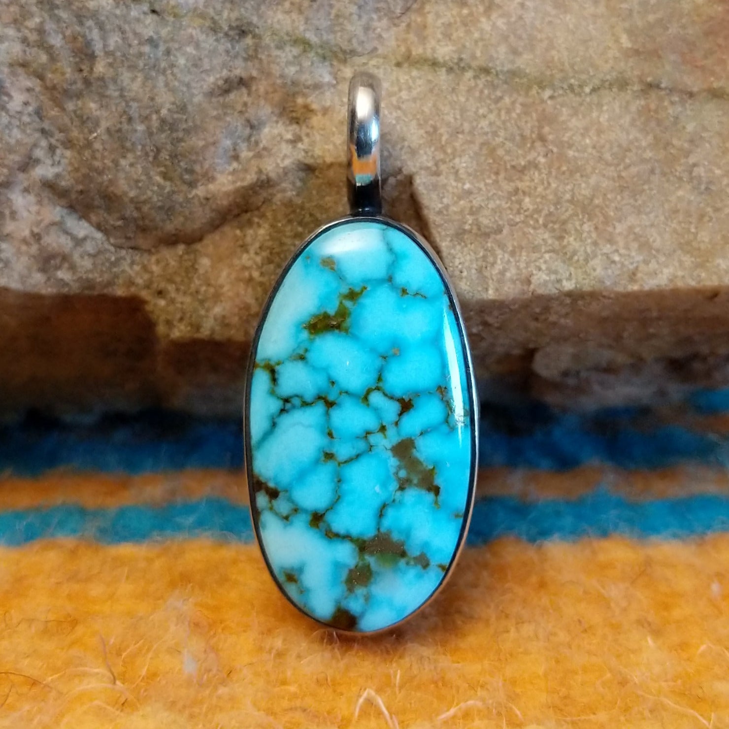 Sterling silver pendant with Kingman turquoise set in the oval bezel.