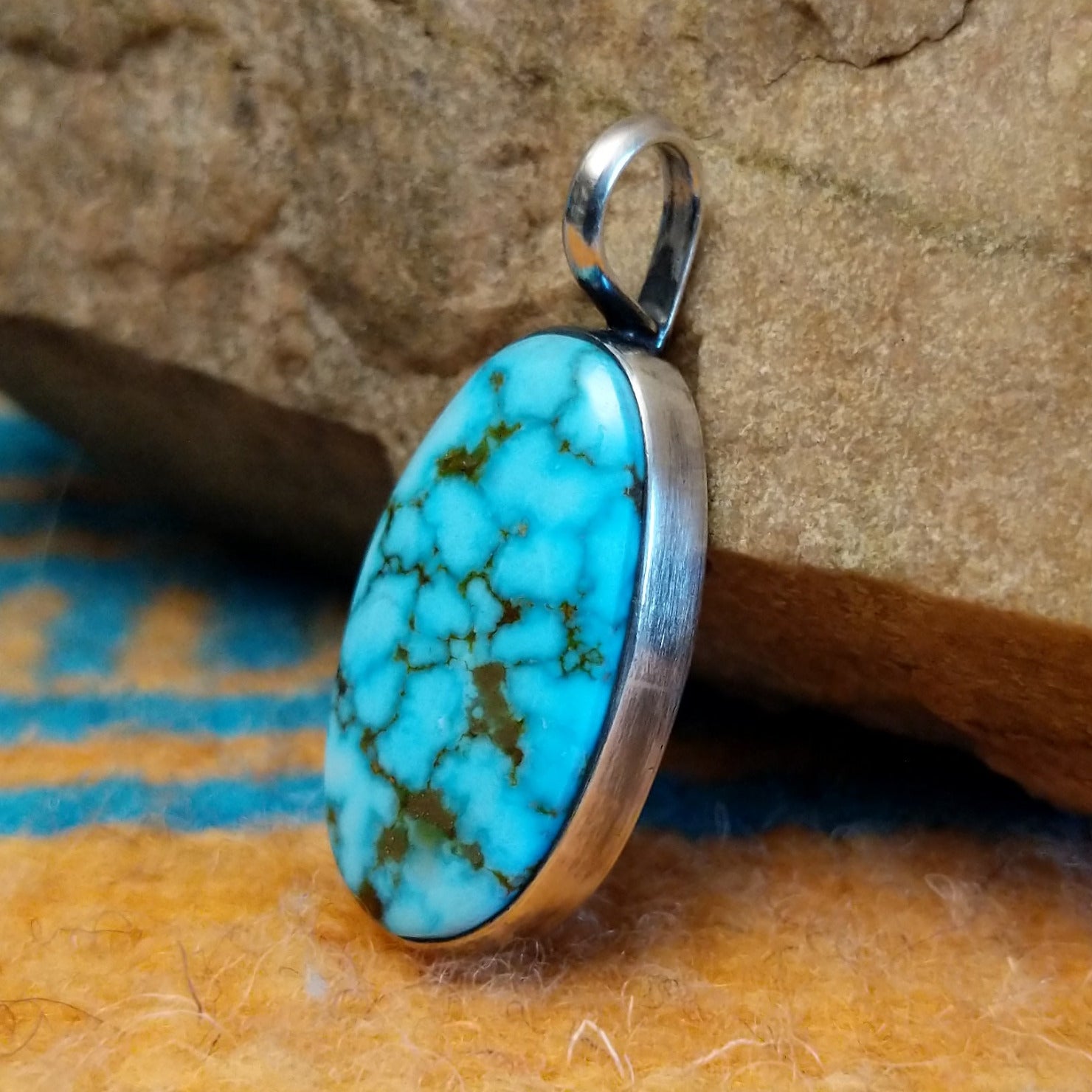 Sterling silver pendant with Kingman turquoise set in the oval bezel.