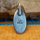 Close-up of the artisan's stamped signature.