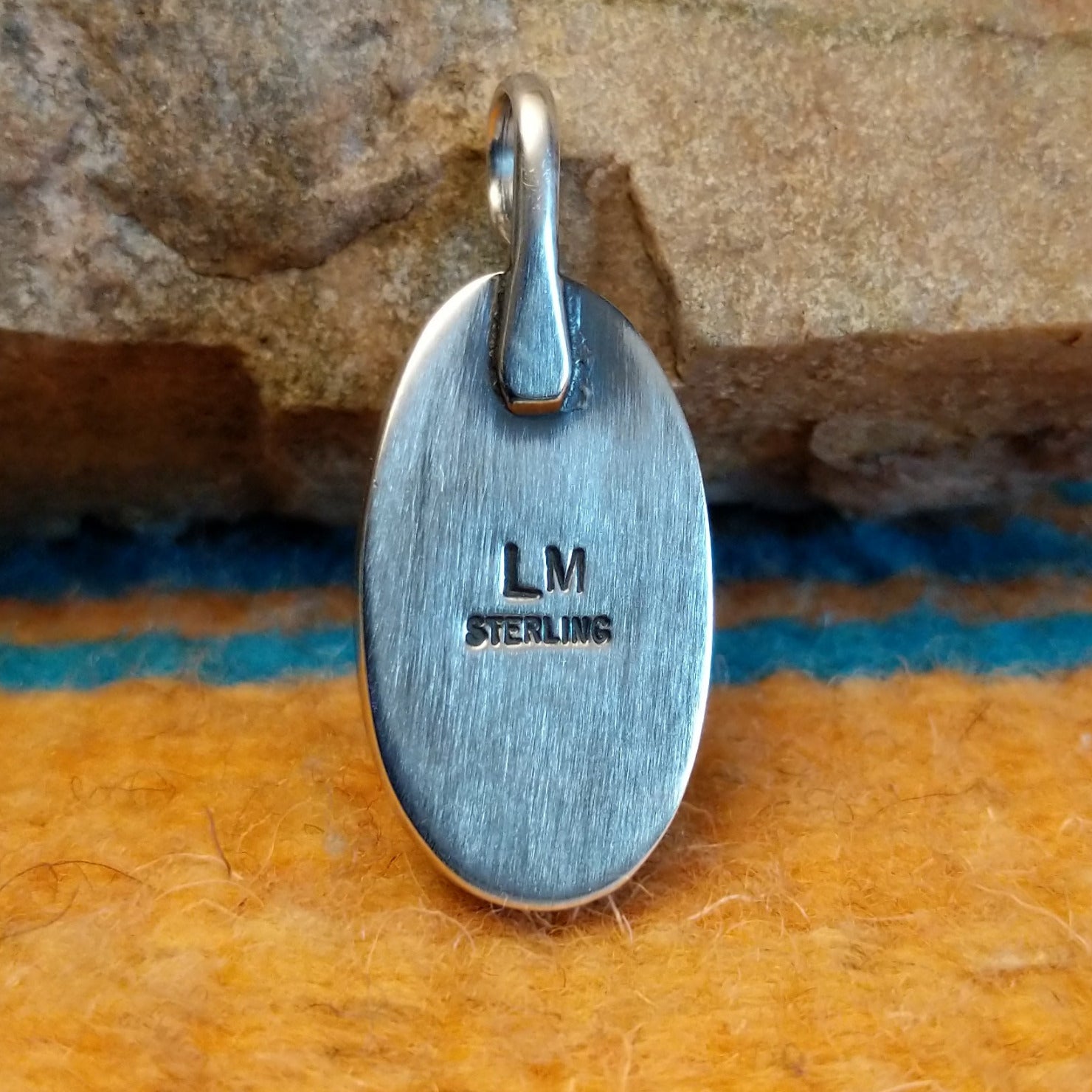 Close-up of the artisan's stamped signature.