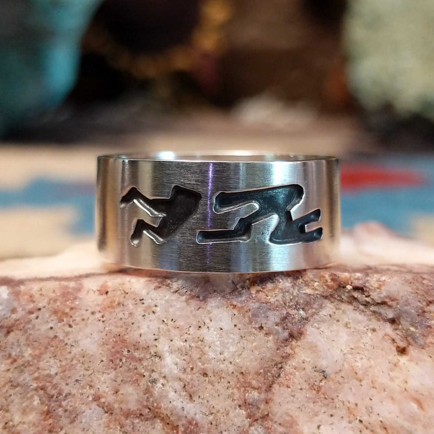 Solid sterling silver ring with Navajo-inspired designs.