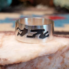 Solid sterling silver ring with Navajo-inspired designs.