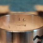 Close-up of the artist's stamped signature.