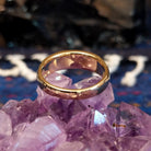 The polished gold band of the ring.