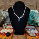 Flowing jewelry set with matching necklace, earrings, and cuff featuring lapis and manmade opal inlays.