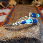 Flowing jewelry set with matching necklace, earrings, and cuff featuring lapis and manmade opal inlays.