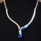 Flowing jewelry set with matching necklace, earrings, and cuff featuring lapis and manmade opal inlays.