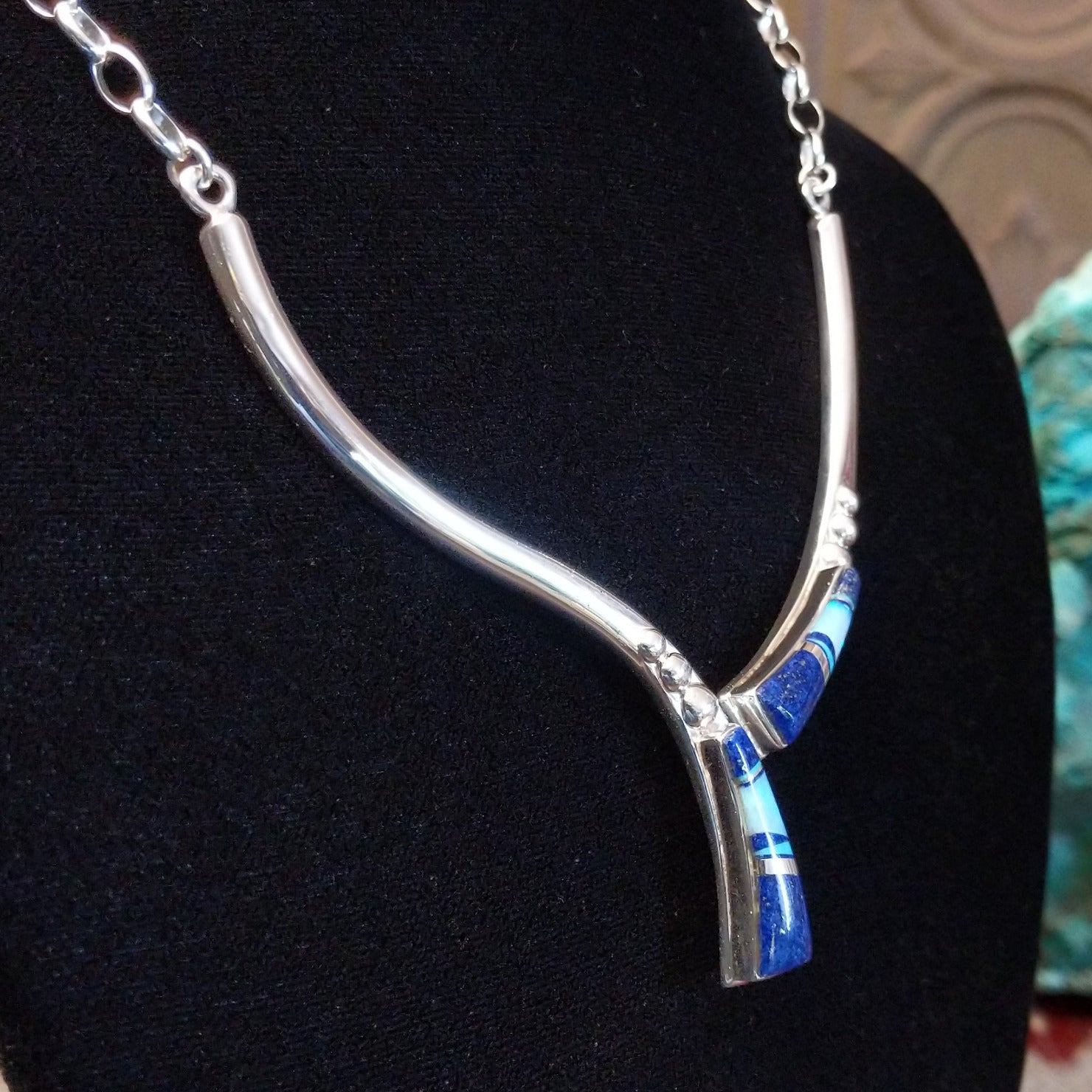 Flowing jewelry set with matching necklace, earrings, and cuff featuring lapis and manmade opal inlays.